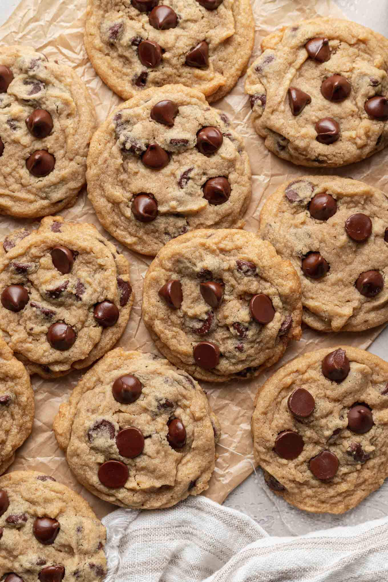 An overhead view of eggless chocolate cookies on parchment paper. 