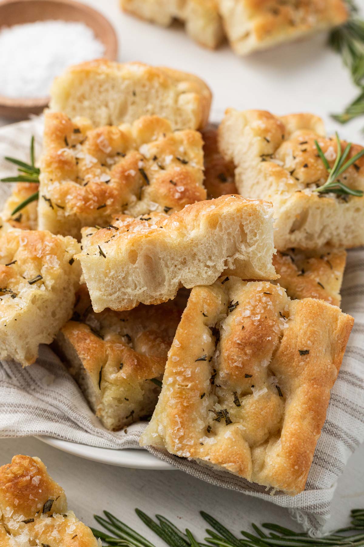 Focaccia slices piled high on a plate. 