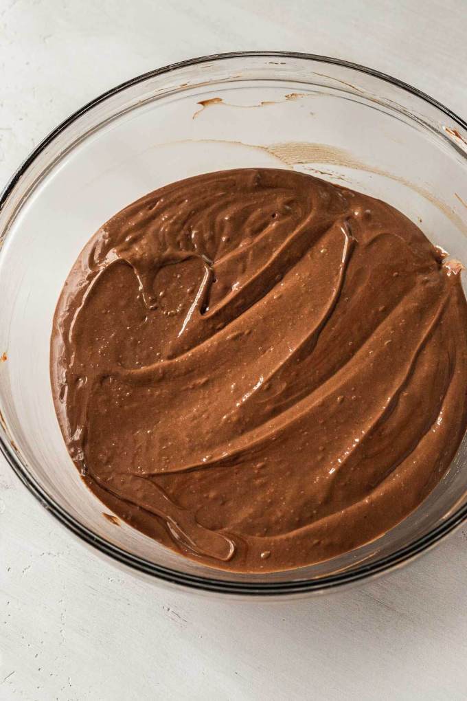 A silky chocolate filling in a glass mixing bowl.