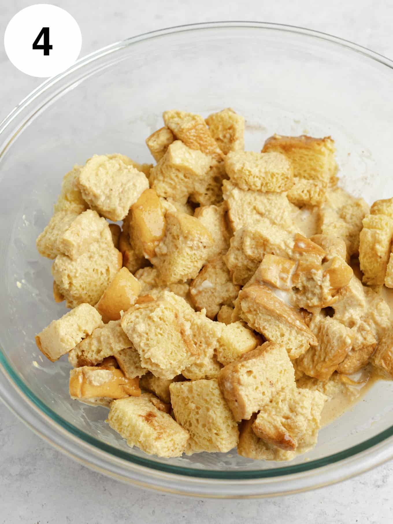 Cubed bread coated in the custard mixture.