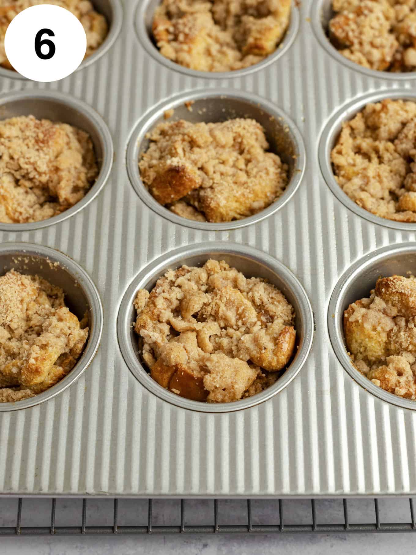 Baked French toast muffins in a muffin pan.