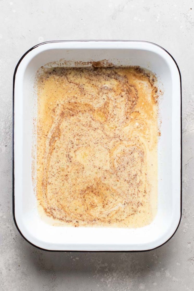 Overhead view of french toast batter in a large baking dish.