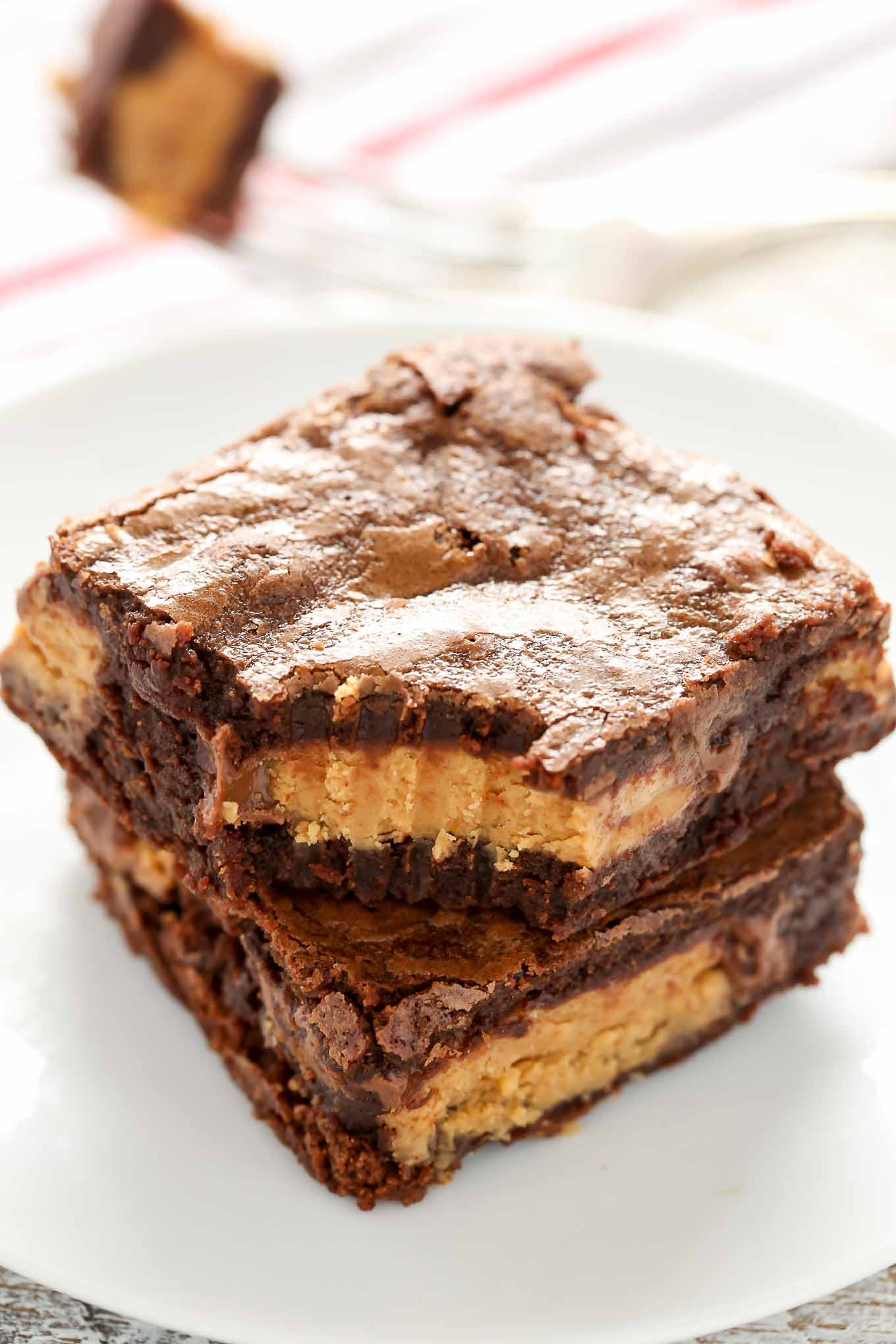 These Fudgy Peanut Butter Cup Brownies start with an easy homemade brownie recipe and are stuffed with peanut butter cups.  These fudgy brownies are the ultimate dessert!