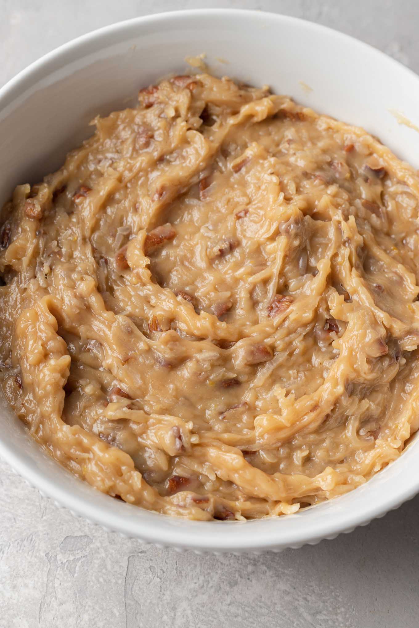 A large bowl of coconut pecan frosting for German chocolate cake. 