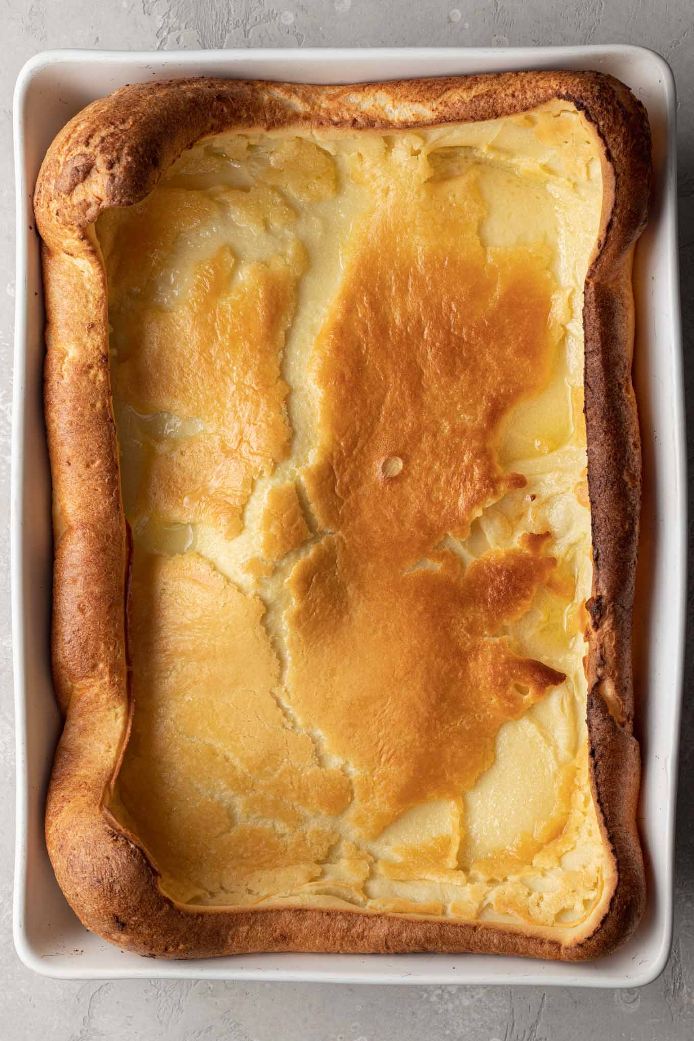 An overhead view of a baked German pancake in a casserole dish. 