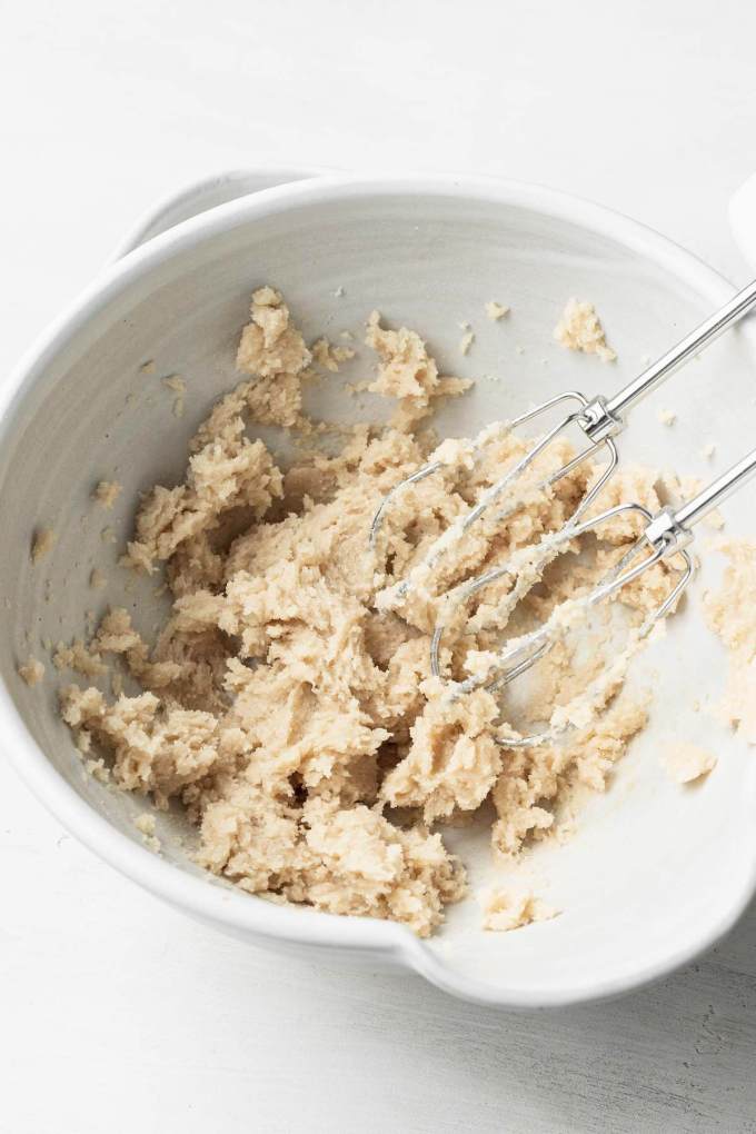 Creamed butter and sugar in a mixing bowl with electric beaters.