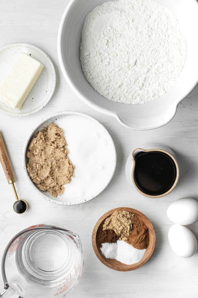 Overhead view of the ingredients needed to make a spiced molasses cake. 