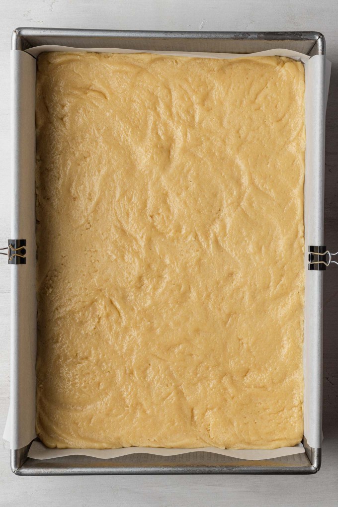 An overhead view of vanilla cake batter in a 9x13-inch pan.