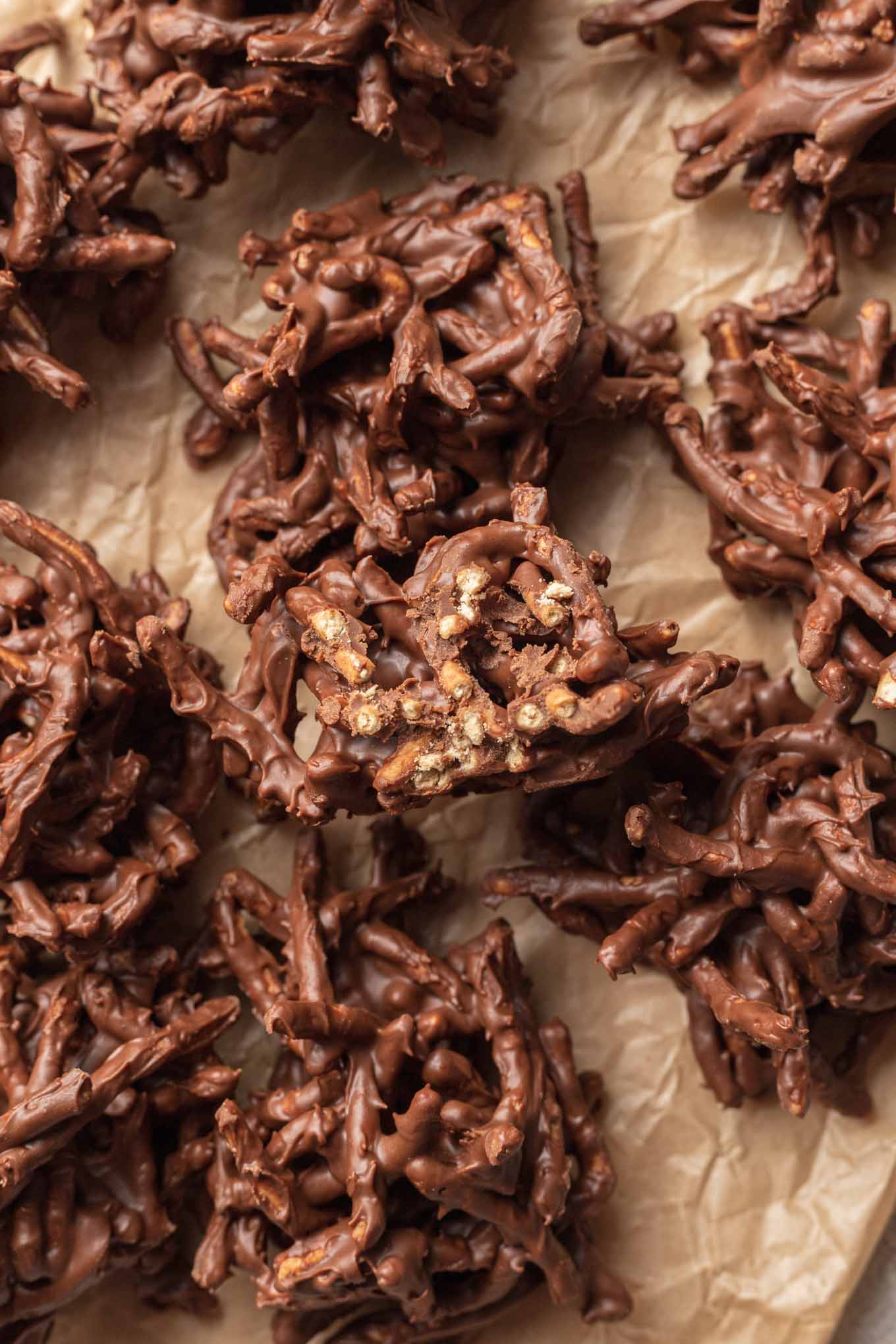 An overhead view of plain haystack cookies on parchment paper. 