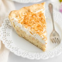 A close-up image of a slice of coconut cream pie on a plate.