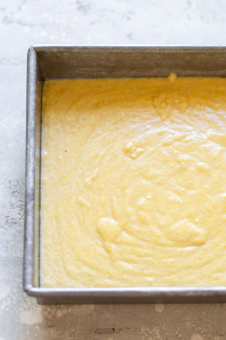 Cornbread batter in an antique metal baking pan ready to go into the oven.