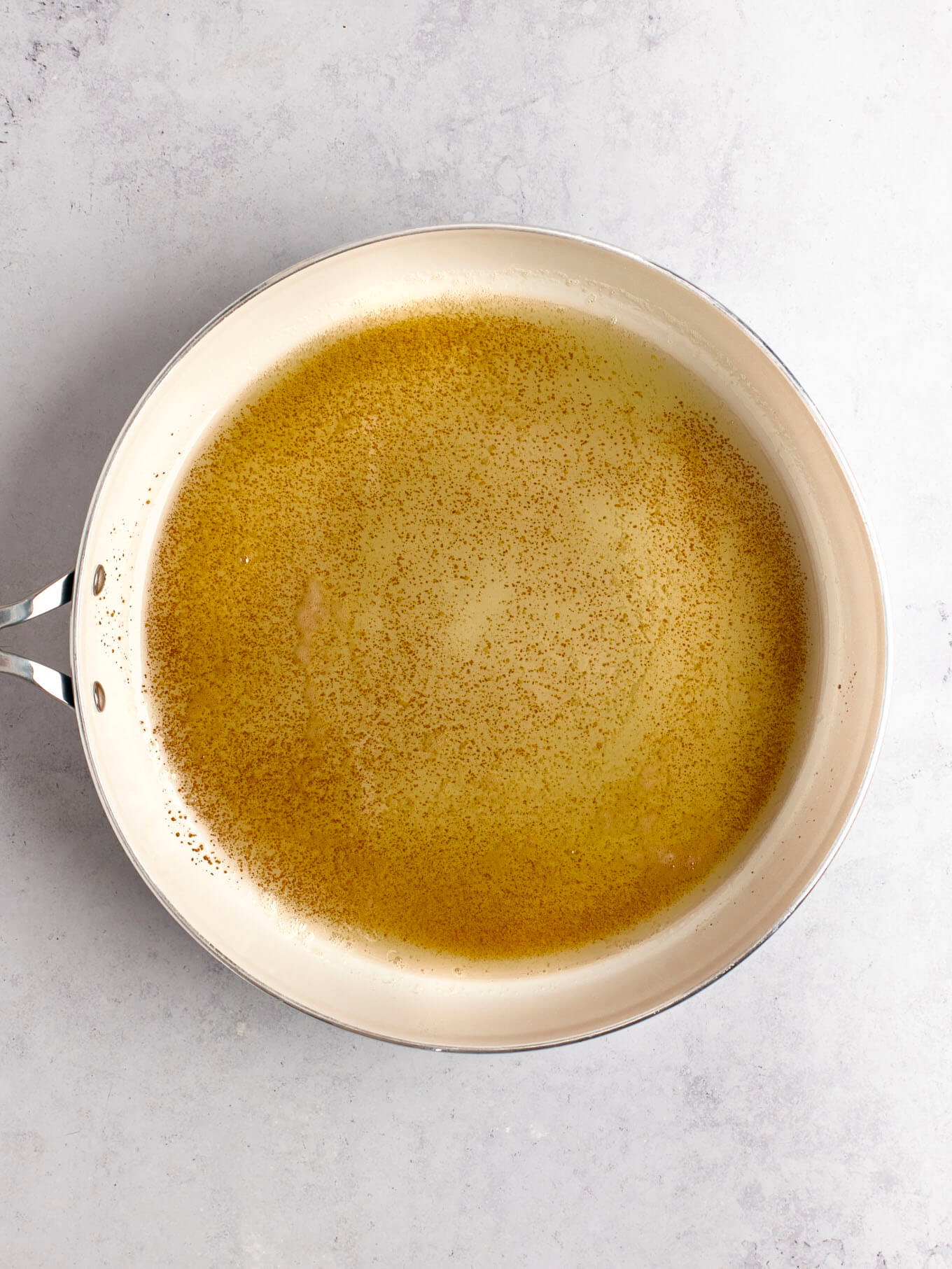 Browned butter in a white skillet.