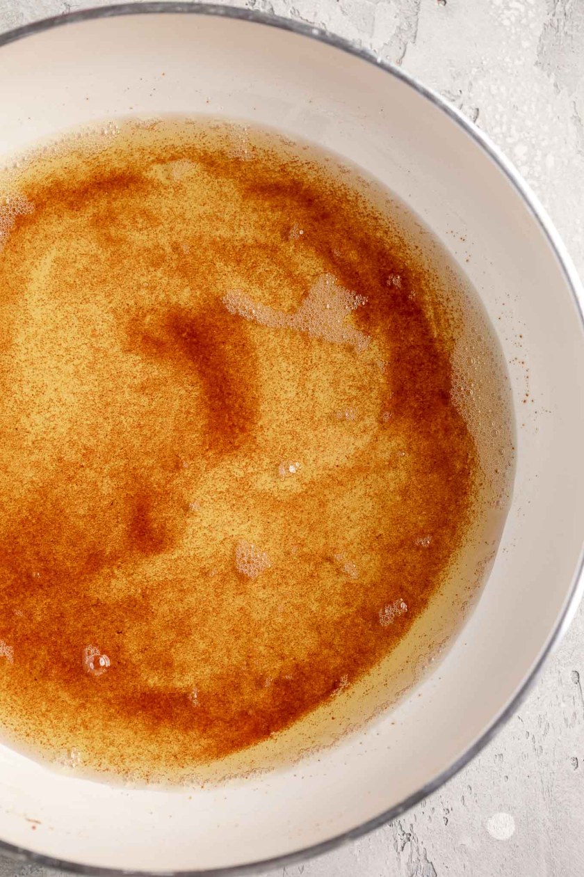 A closeup view of brown butter in a skillet.