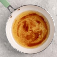 An overhead view of brown butter in a skillet.