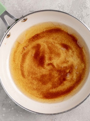 An overhead view of brown butter in a skillet.