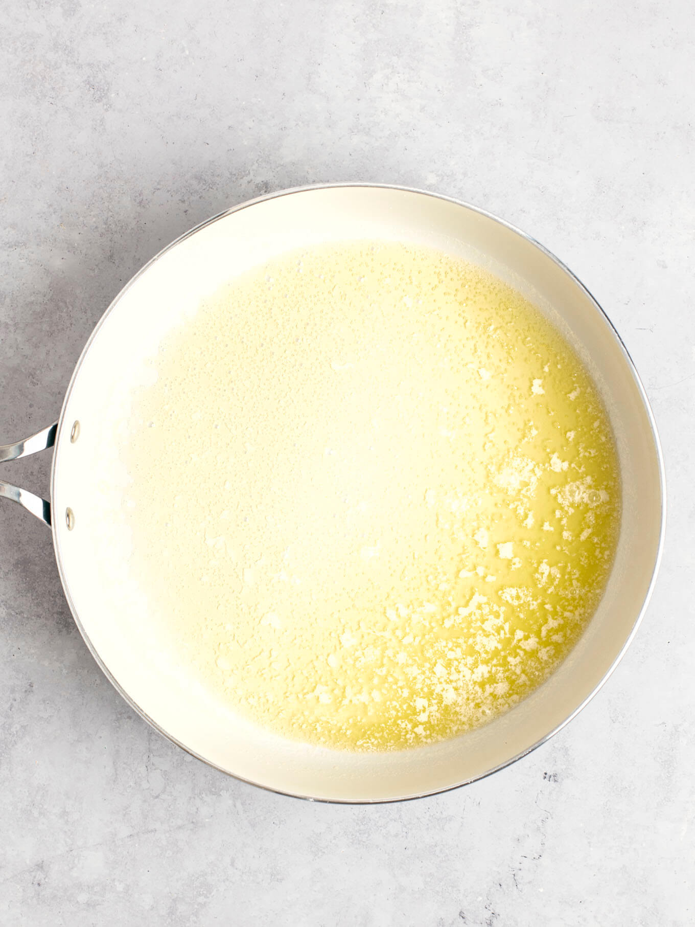 Melted butter in a white skillet.