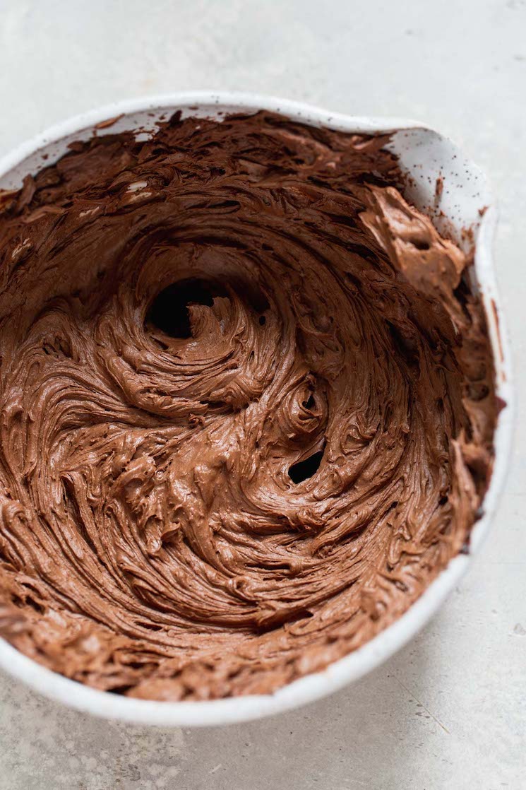 A mixing bowl filled with chocolate ganache that has been whipped.