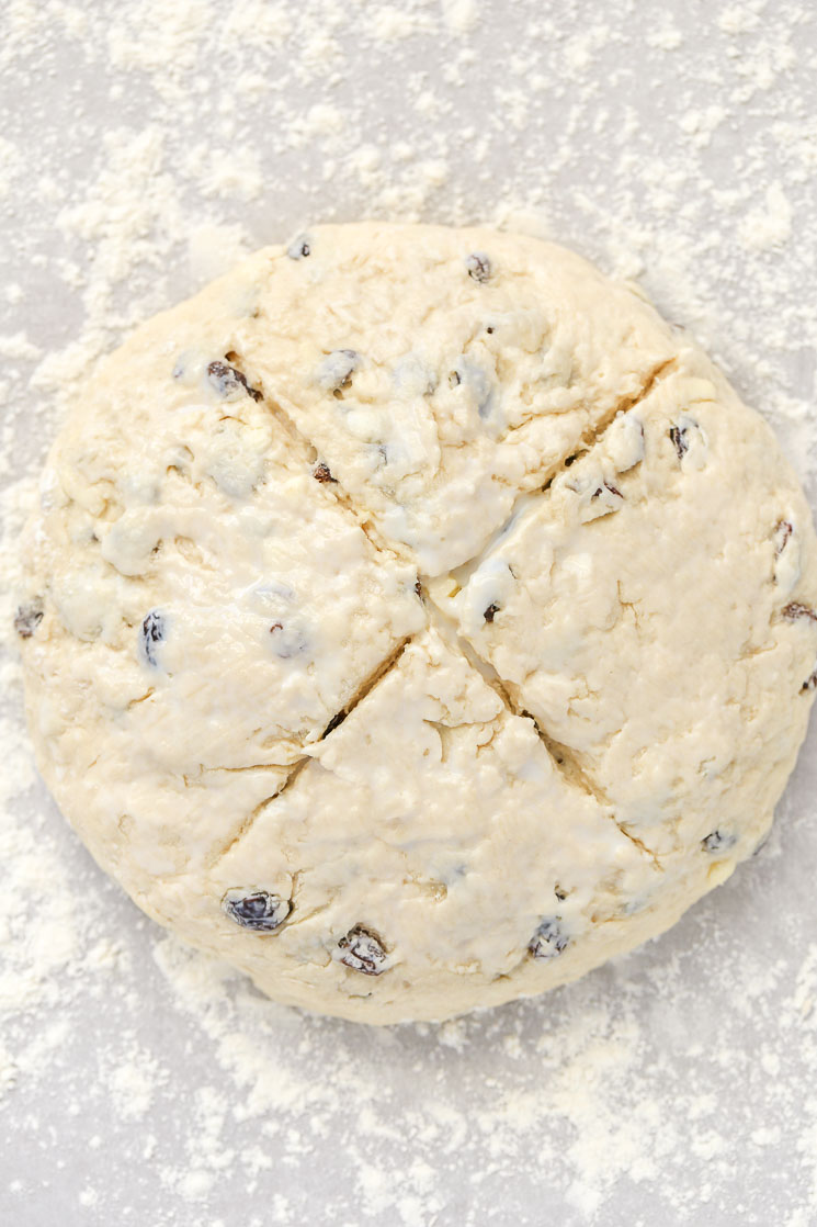 A loaf of Irish Soda Bread with an 'X' cut in the top.