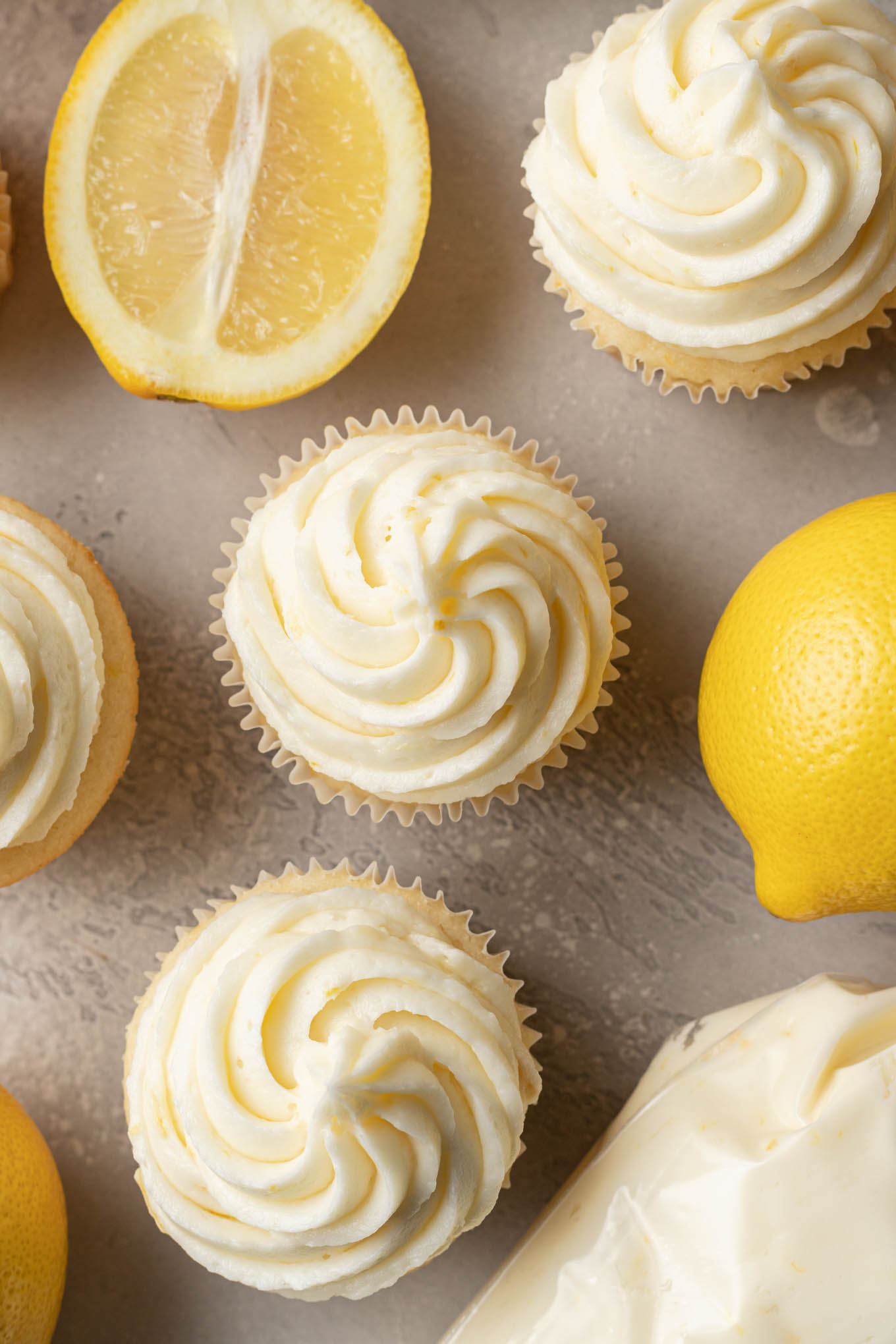 An overhead view of cupcakes frosted with lemon buttercream. 