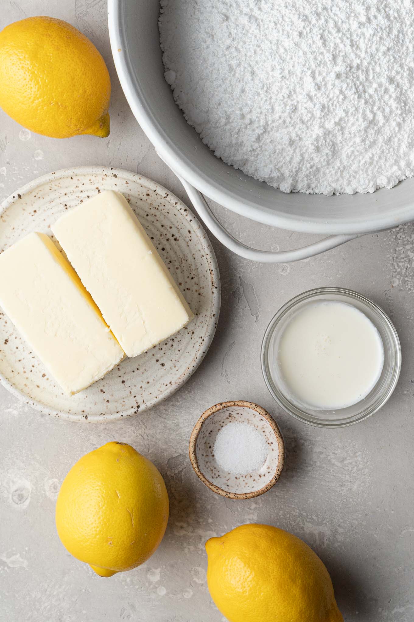 An overhead view of the ingredients needed to make lemon buttercream frosting. 