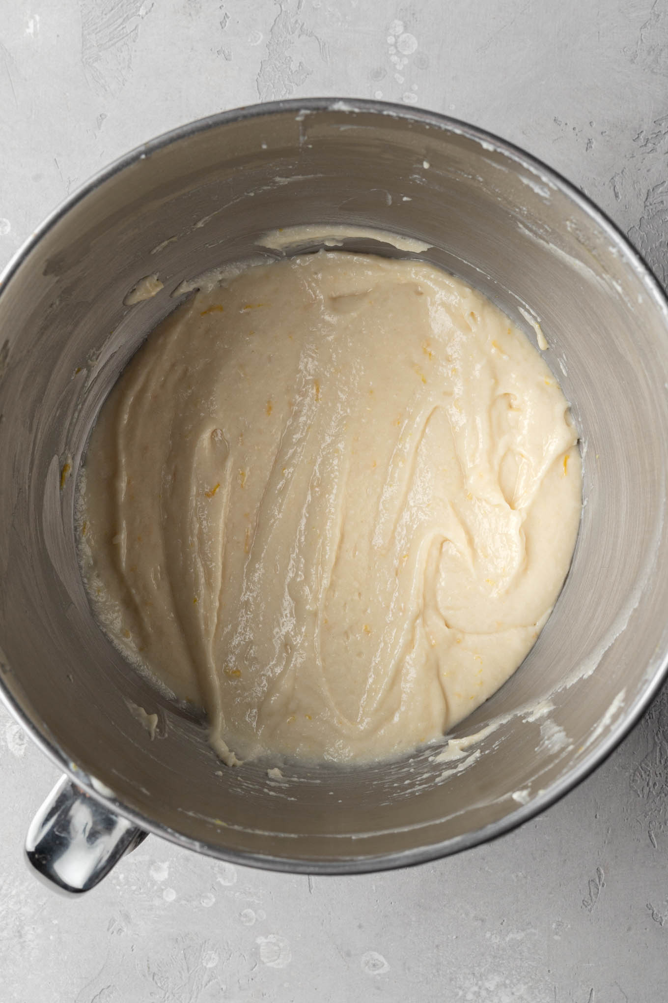 An overhead view of lemon cupcake batter in a mixing bowl. 