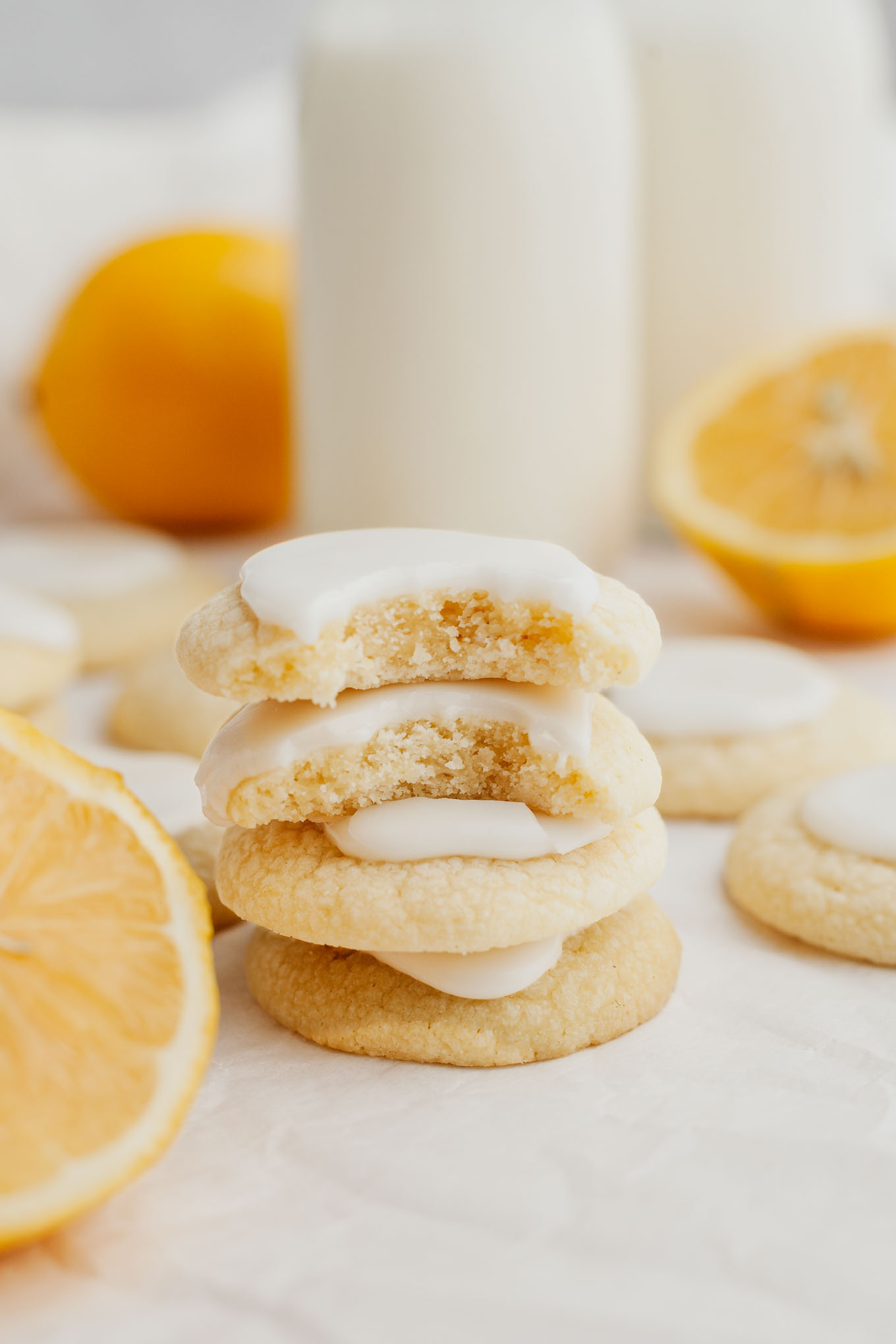 A stack of four lemon meltaways, surrounded by more cookies. 