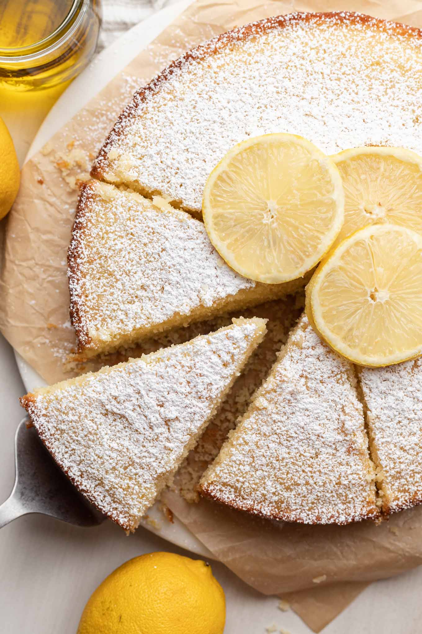 An overhead view of a sliced lemon olive oil cake. 