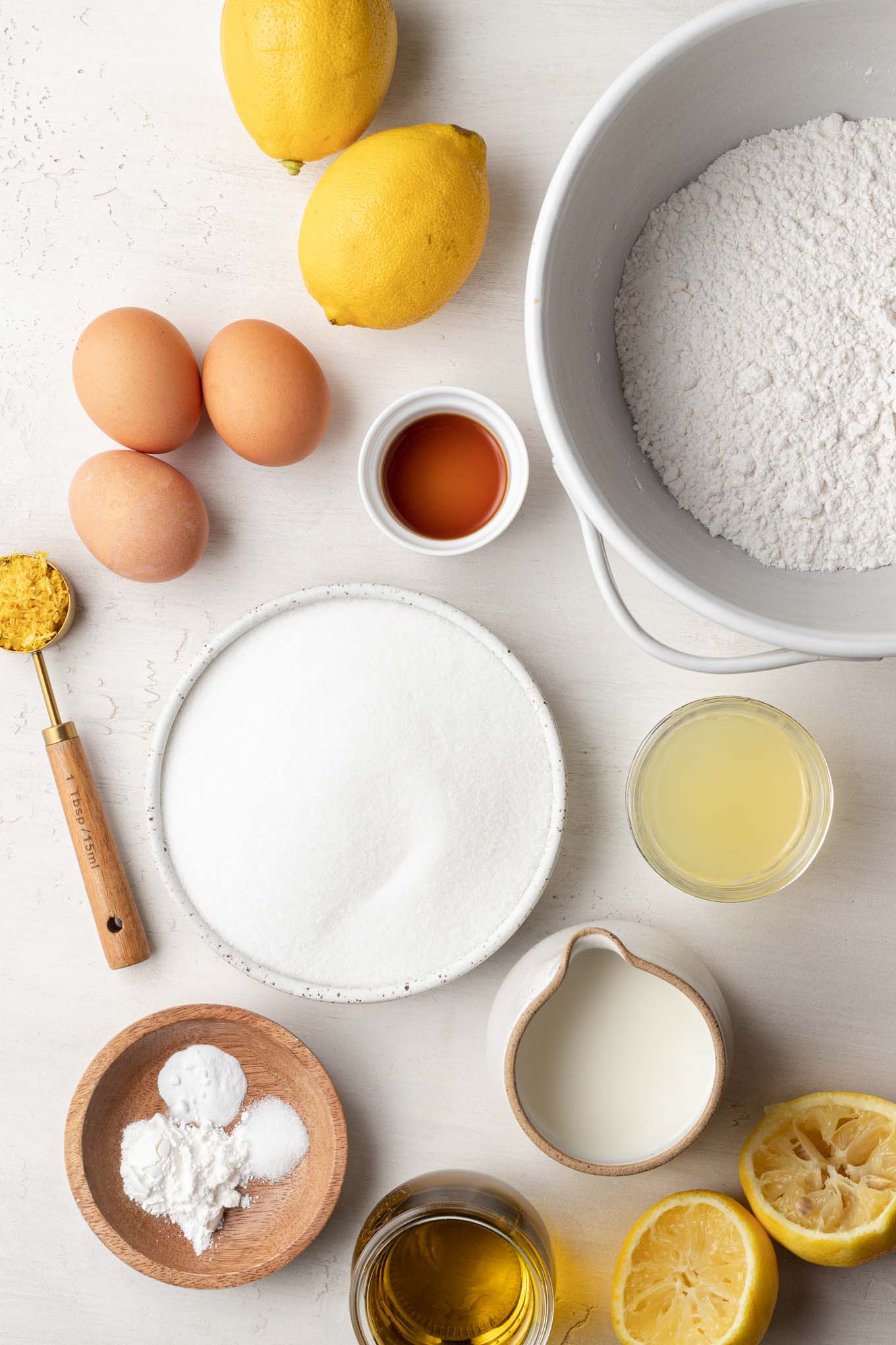 An overhead view of the ingredients needed to make an olive oil cake with lemon.