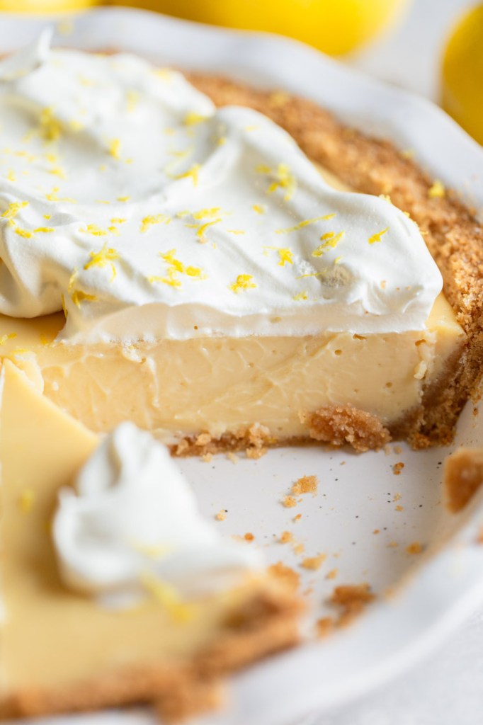 The finished lemon pie with one slice removed to show the texture of the lemon filling.