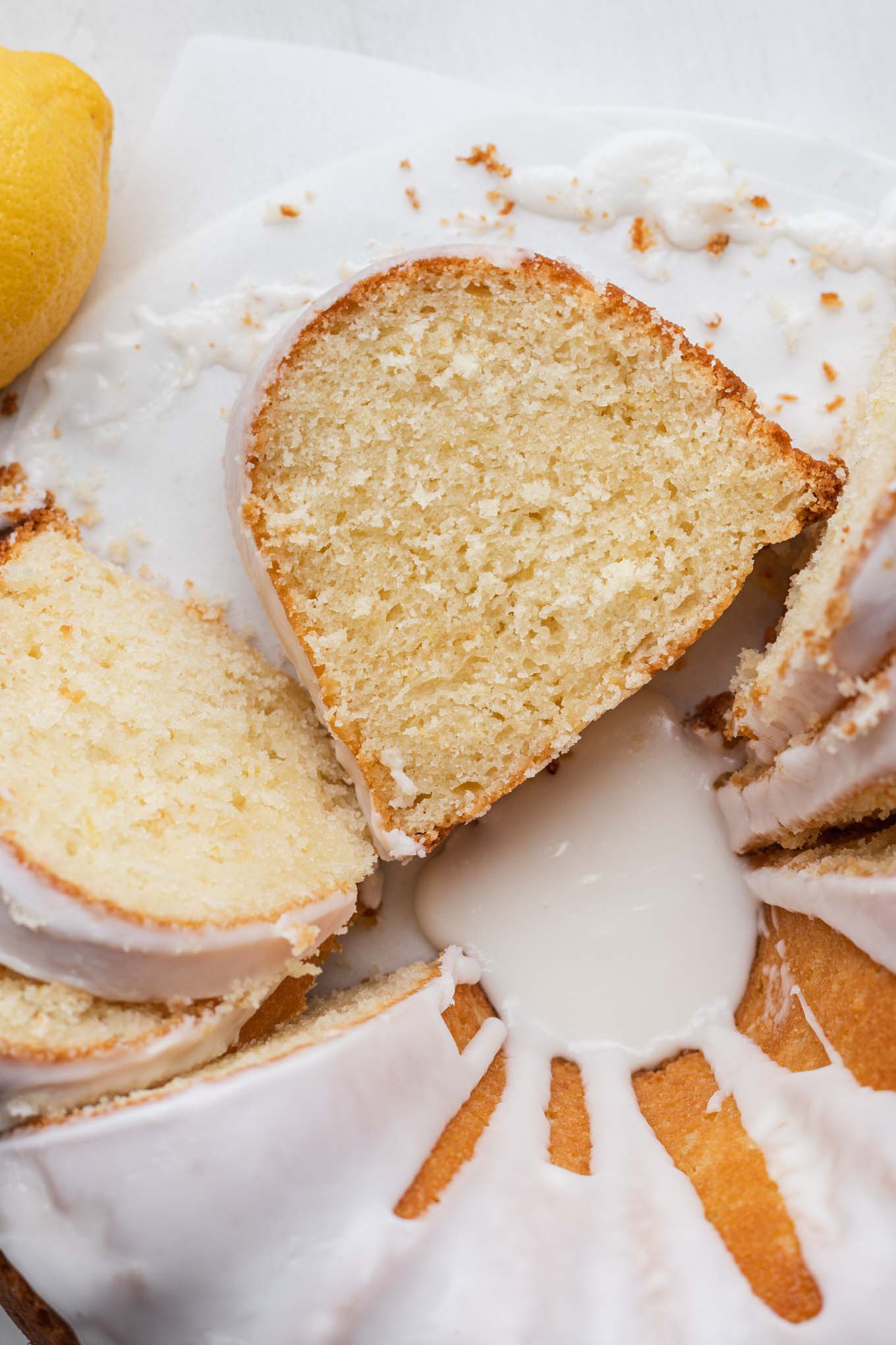 A close up, overhead view of a sliced lemon sour cream pound cake. 