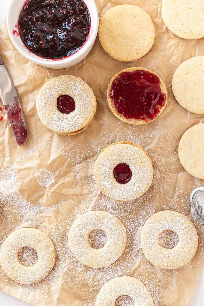 An overhead view of Linzer tart cookies being assembled.