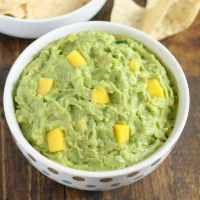 This mango guacamole makes a fun appetizer for any party and comes together in just a few minutes!  Serve it with some tortilla chips for a quick and easy appetizer or snack.