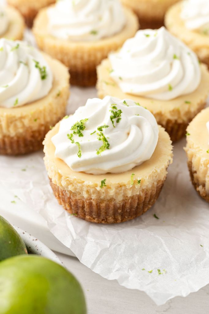 Mini key lime pies on a parchment paper-lined plate. 