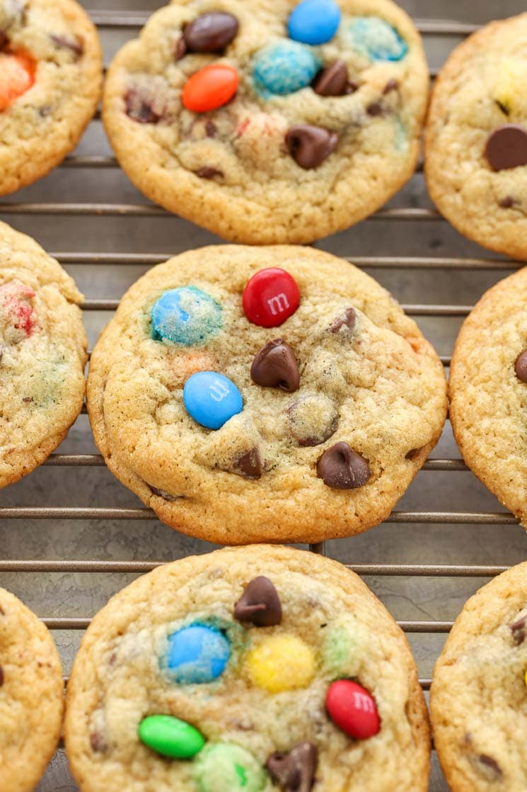 Chocolate chip M&M's cookies cooling on a wire rack. 