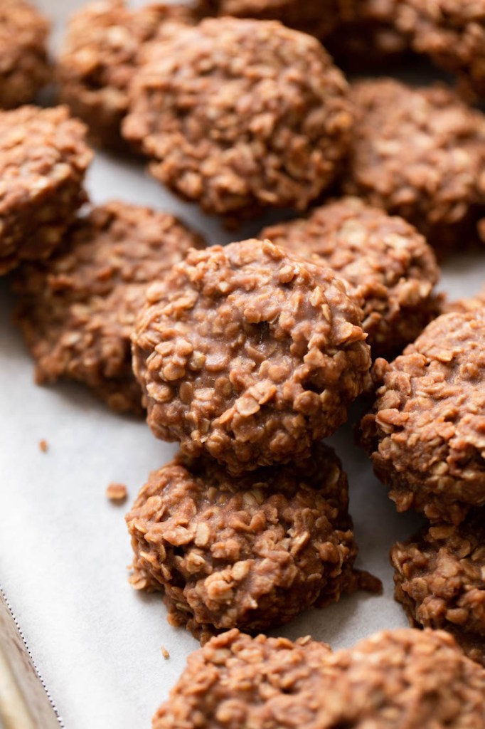 Several no-bake cookies on a piece of parchment paper.