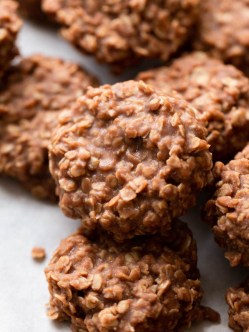 Several no-bake cookies on a piece of parchment paper.