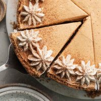 A close-up overhead view of a no-bake pumpkin cheesecake that's been sliced.