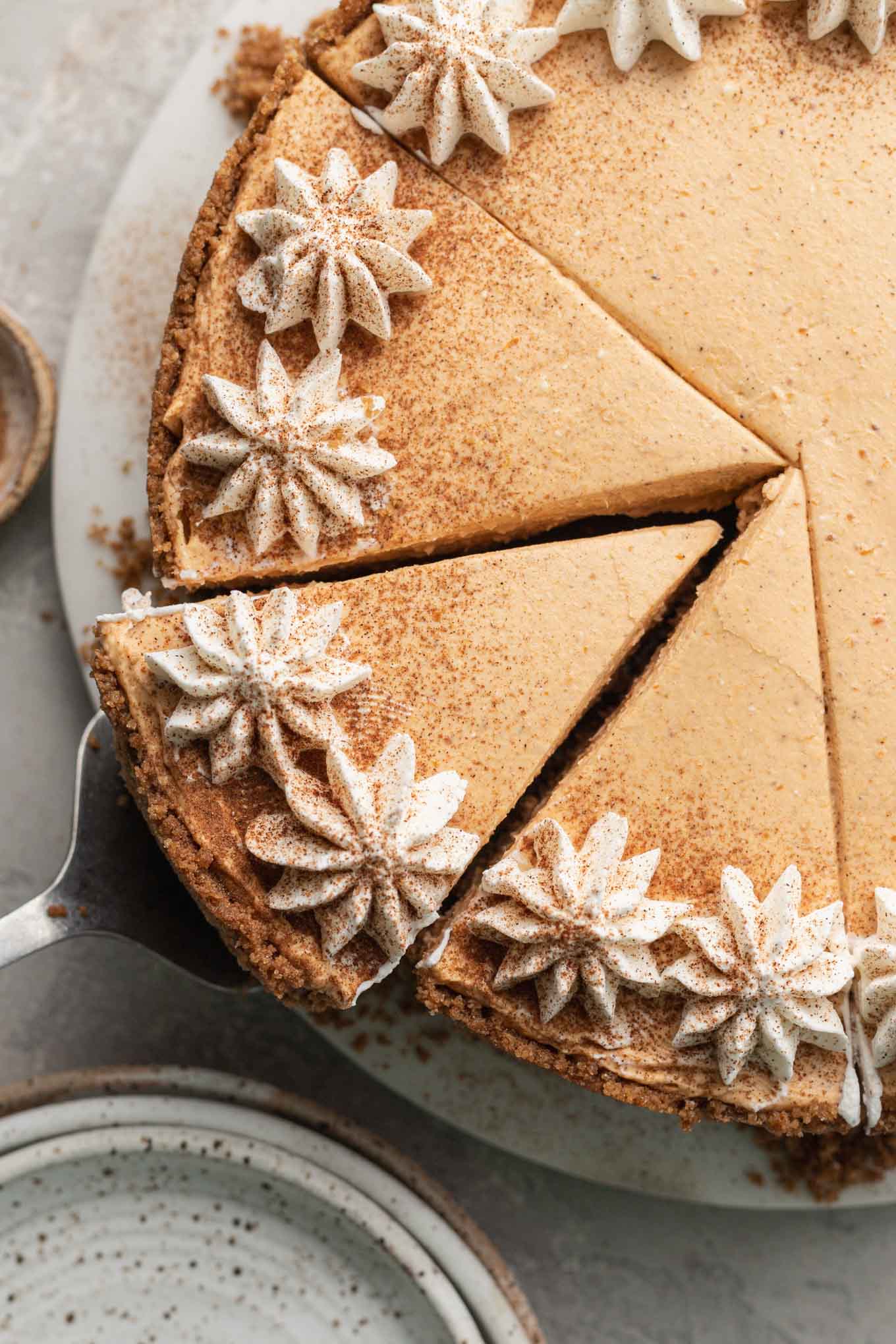 An overhead view of a sliced no-bake pumpkin cheesecake. 