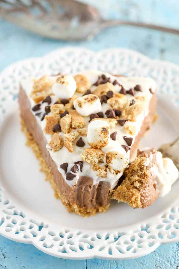 A homemade graham cracker crust topped with a no-bake chocolate cheesecake filling and marshmallow fluff whipped cream. This No-Bake S'mores Cheesecake is the ultimate summer dessert!