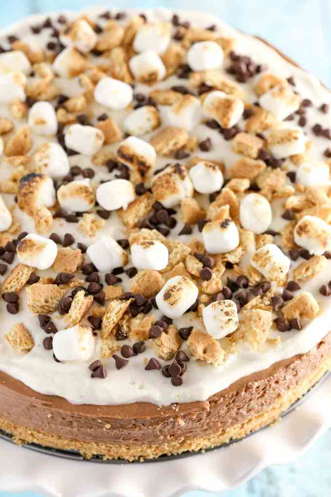 A homemade graham cracker crust topped with a no-bake chocolate cheesecake filling and marshmallow fluff whipped cream. This No-Bake S'mores Cheesecake is the ultimate summer dessert!