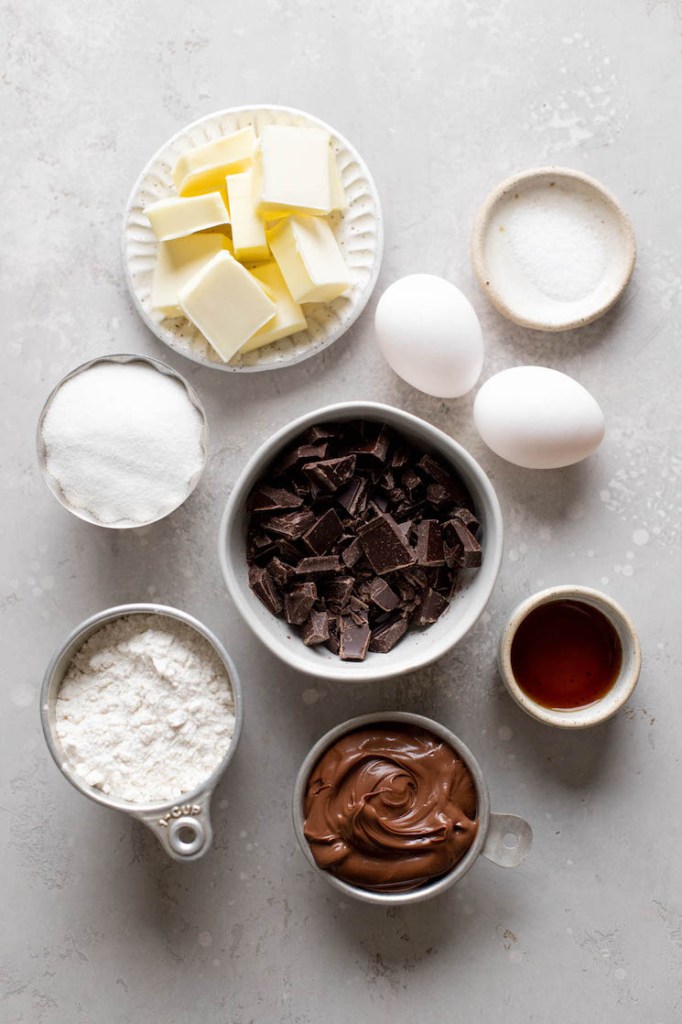 An overhead view of the ingredients needed to make homemade brownies with Nutella. 