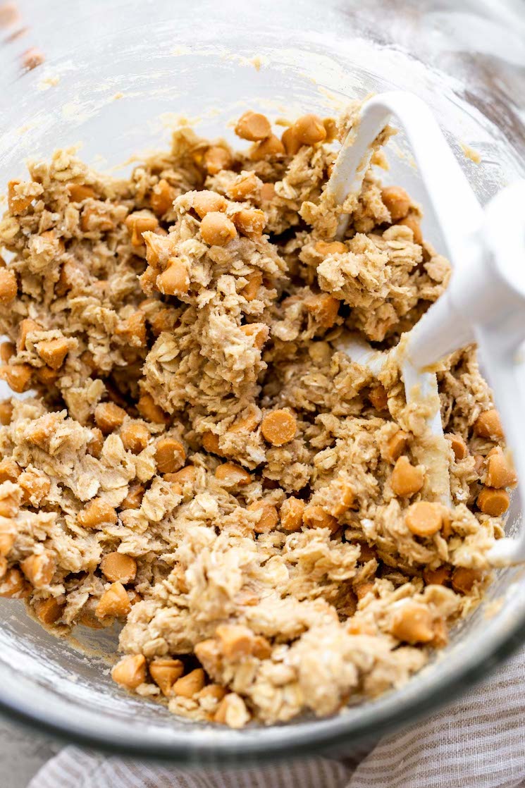 A glass mixing bowl filled with cookie dough.