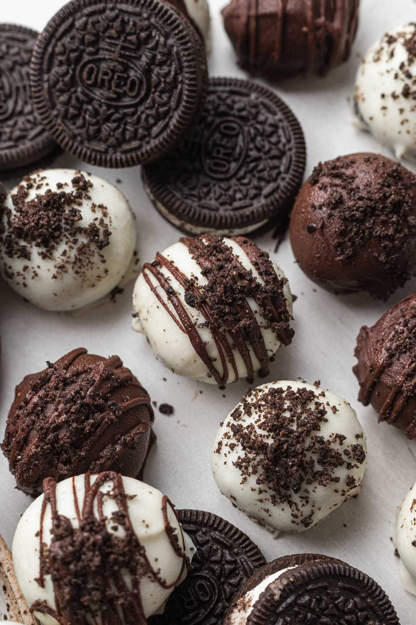 A close-up, overhead view of Oreo cookie balls next to actual Oreo cookies. 