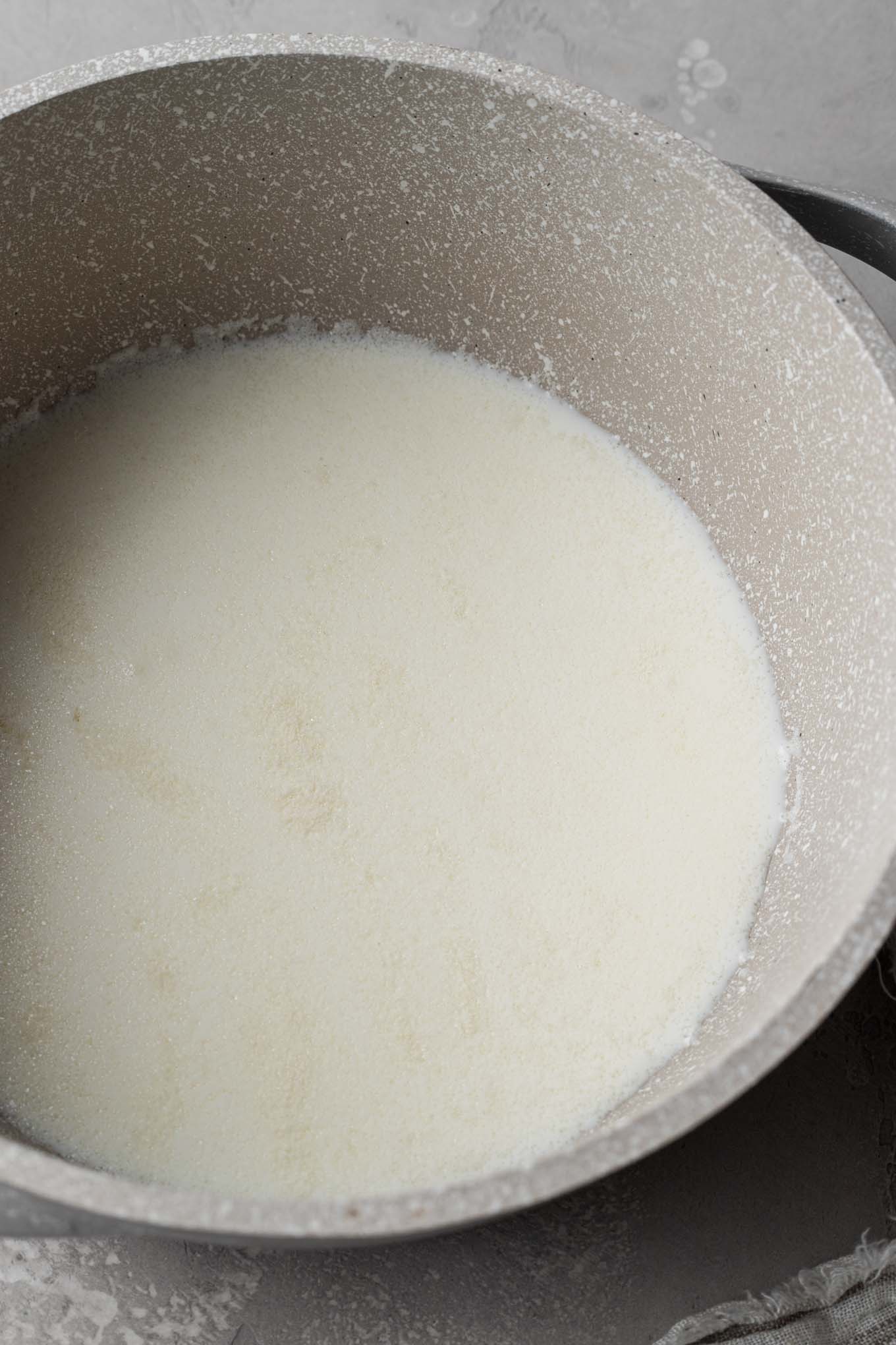 An overhead view of gelatin blooming in milk.