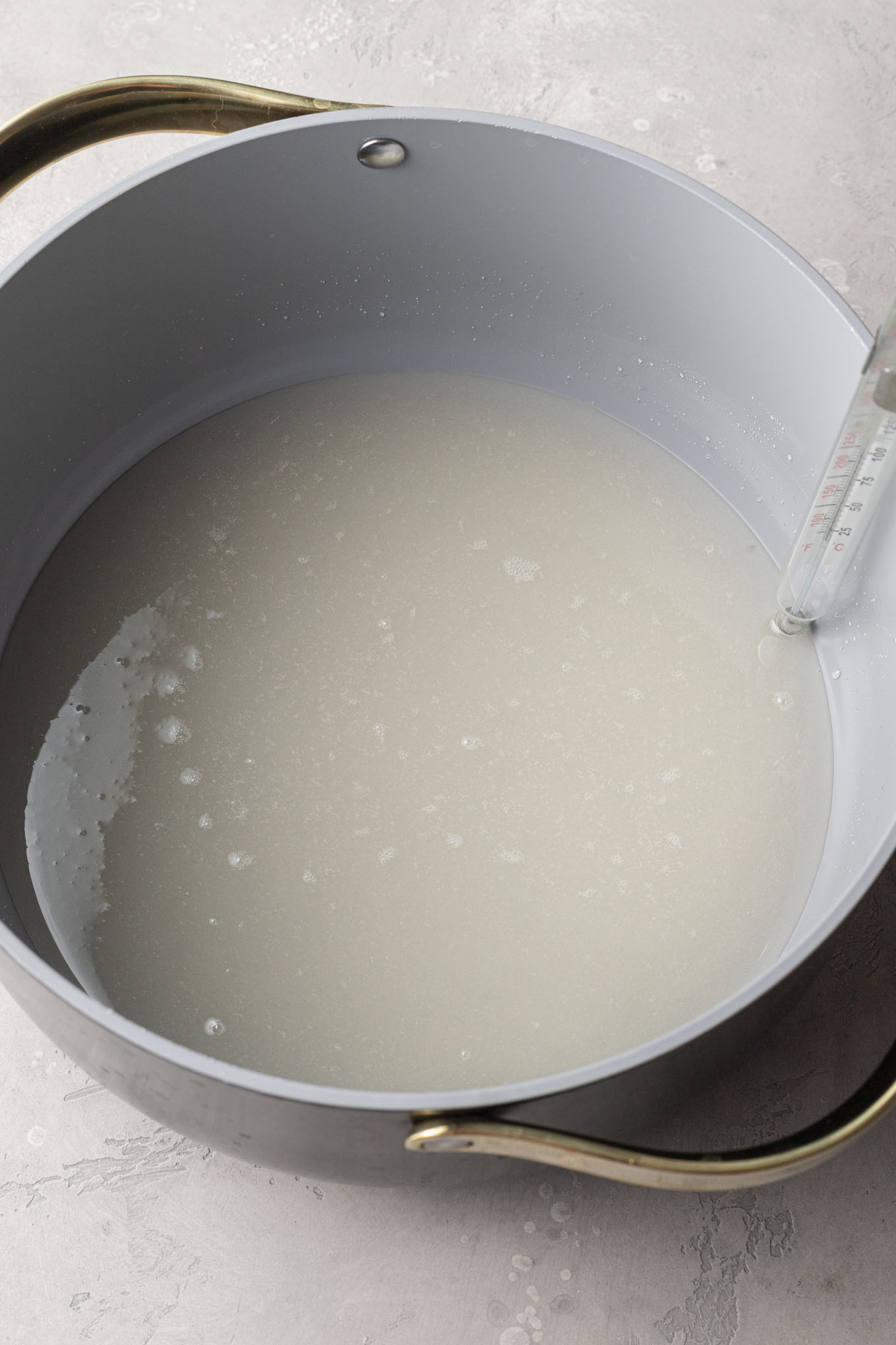 An overhead view of corn syrup and sugar in a saucepan. 