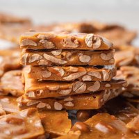 Several piece of peanut brittle stacked on top of each other.