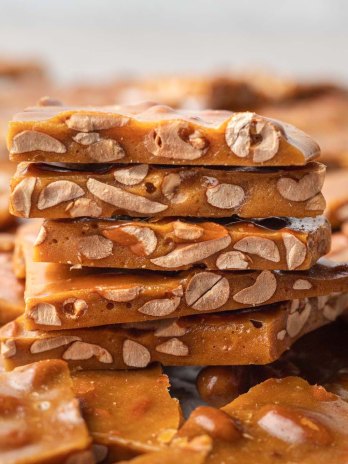 Several piece of peanut brittle stacked on top of each other.