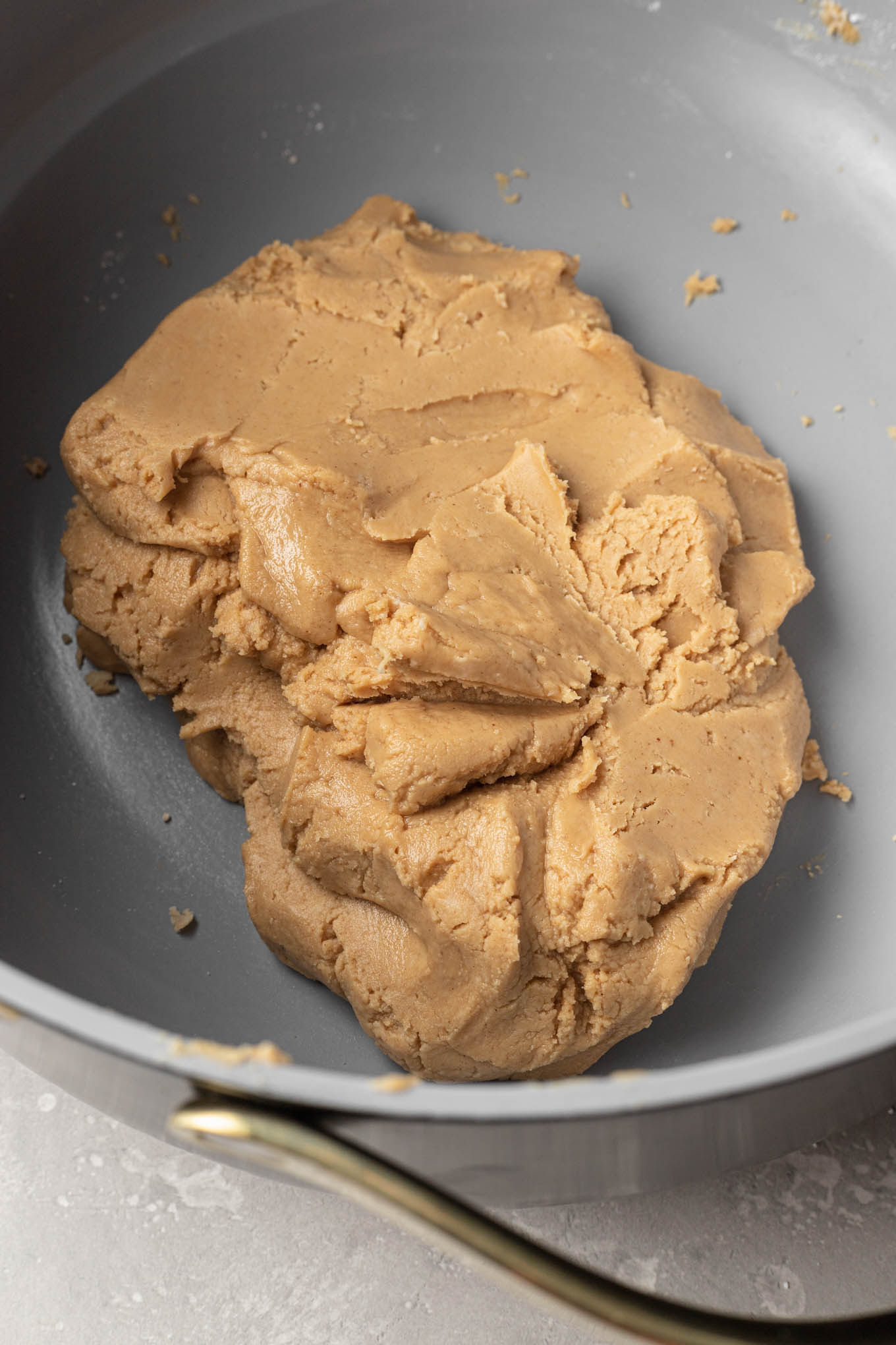 An overhead view of peanut butter filling in a saucepan.