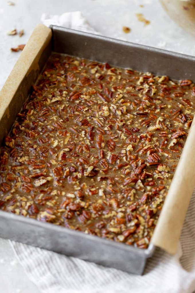 The pecan pie filling added on top of the shortbread crust.