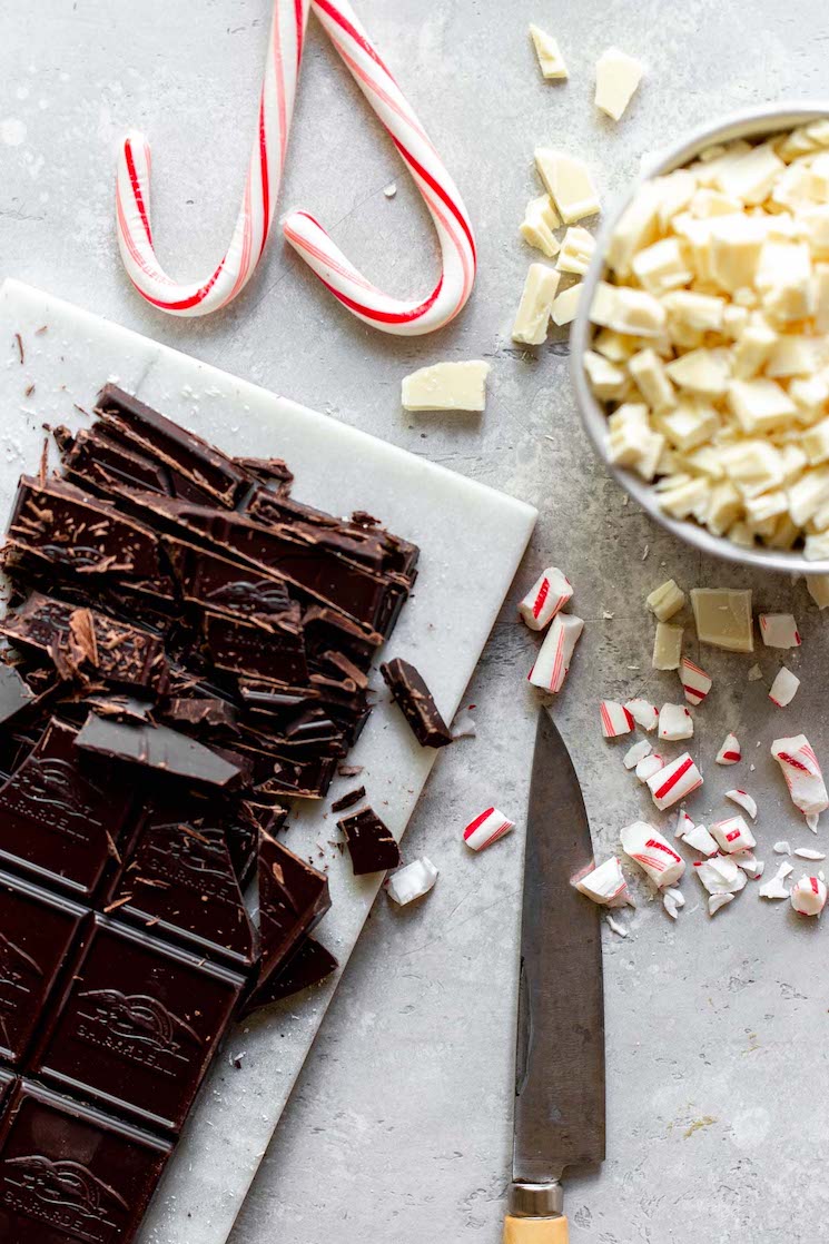 The ingredients needed to make peppermint bark sitting on top of a gray surface.